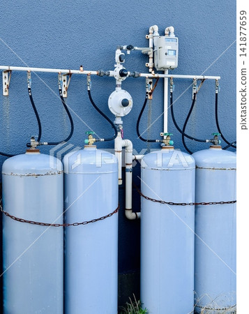 Residential gas equipment with LP gas cylinders and piping lined up. Residential gas equipment with LP gas cylinders and piping lined up. 141877659