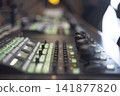 Professional video production switcher console with glowing green buttons and copy space 141877820