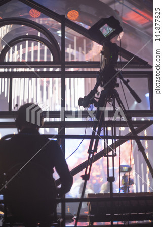 Cameraman with professional TV camera filming live concert on stage with copy space Cameraman with professional TV camera filming live concert on stage with copy space 141877825
