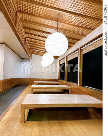 A restaurant with a raised seating area that is empty right after opening. A restaurant with a raised seating area that is empty right after opening. 141878069
