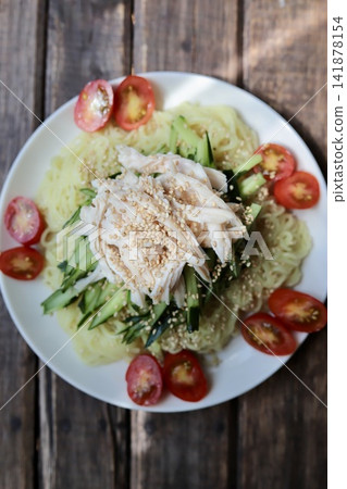 Chilled ramen with shredded salad chicken moistened with salt koji. Chilled ramen with shredded salad chicken moistened with salt koji. 141878154