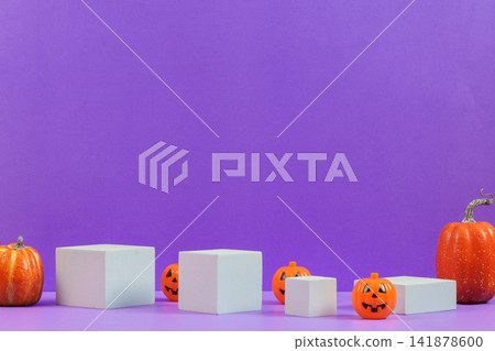 Halloween product display mockup with white podiums jack-o-lanterns and pumpkins on purple background Halloween product display mockup with white podiums jack-o-lanterns and pumpkins on purple background 141878600