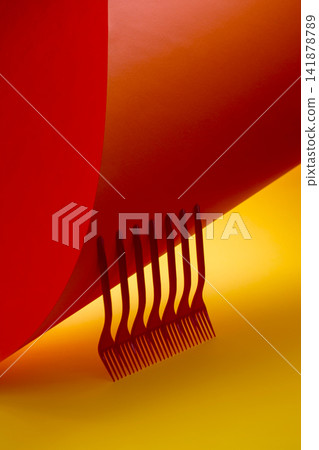 Abstract still life with red forks on a colored background Abstract still life with red forks on a colored background 141878789
