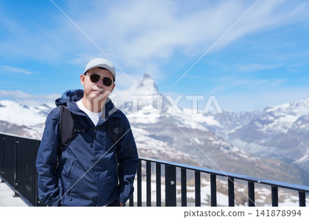 man Tourist Exploring Zermatt, Switzerland. happy Traveler sightseeing iconic Matterhorn Swiss Alps Viewpoint, Famous European Landmark, Popular Tourist Attraction and Travel Destination in Europe man Tourist Exploring Zermatt, Switzerland. happy Traveler sightseeing iconic Matterhorn Swiss Alps Viewpoint, Famous European Landmark, Popular Tourist Attraction and Travel Destination in Europe 141878994