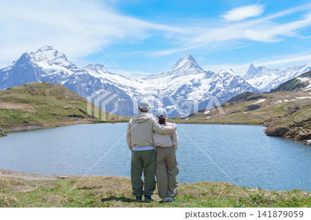 Couple Tourist Explore Grindelwald First, Switzerland in Summer. Hiker visit Bachalpsee Lake and Swiss Alps in Jungfrau Region. Famous Traveler Attraction, Travel Destination and hiking trail 141879059