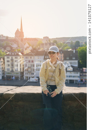 Woman Tourist Exploring Zurich, Switzerland in Summer. Traveler Visit Lindenhof Hill Viewpoint Over Zurich Old Town and Limmat River, Famous European Tourist Attraction and Europe Travel Destination Woman Tourist Exploring Zurich, Switzerland in Summer. Traveler Visit Lindenhof Hill Viewpoint Over Zurich Old Town and Limmat River, Famous European Tourist Attraction and Europe Travel Destination 141879127