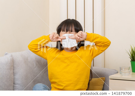 Asian girl blowing nose with tissue sick child flu cold healthcare concept 141879700