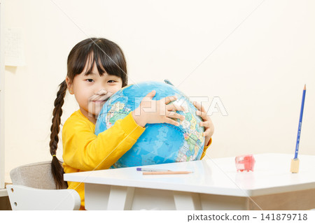 Asian little girl hugging globe, learning geography, curious child exploring world, education concept Asian little girl hugging globe, learning geography, curious child exploring world, education concept 141879718