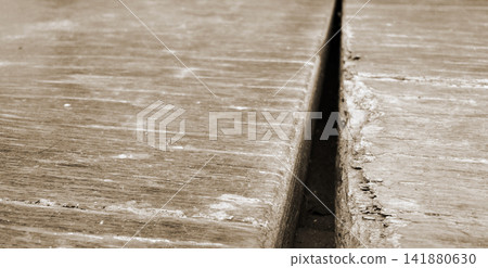 Gap between rotted wooden planks Gap between rotted wooden planks 141880630