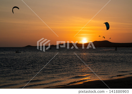 Kitesurfers Silhouetted at Sunset in Cabo de la Vela, La Guajira Kitesurfers Silhouetted at Sunset in Cabo de la Vela, La Guajira 141880903