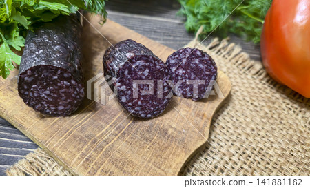 Traditional smoked sausage with fresh dill and tomatoes on a rustic wooden table. Traditional smoked sausage with fresh dill and tomatoes on a rustic wooden table. 141881182