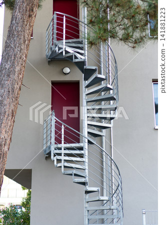 Metal spiral staircase outside the building 141881223