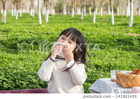 Adorable child cleaning mouth with tissue after meal, healthy habits and hygiene concept. Adorable child cleaning mouth with tissue after meal, healthy habits and hygiene concept. 141881438