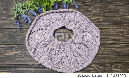 Knitted sweater collar in progress, using knitting needles and stitch markers. Knitted sweater collar in progress, using knitting needles and stitch markers. 141881953
