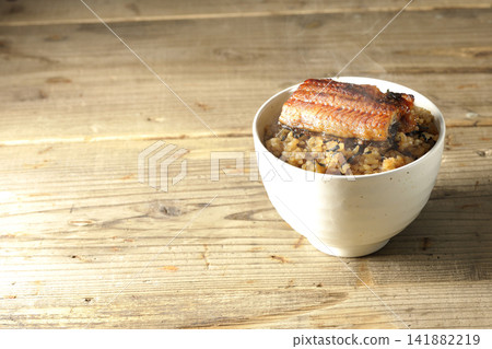 A single photo of a piping hot mini eel rice bowl. A single photo of a piping hot mini eel rice bowl. 141882219