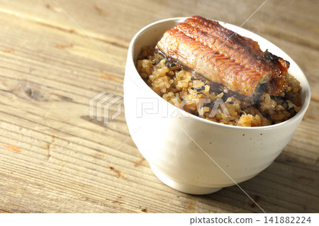 A single photo of a piping hot mini eel rice bowl. A single photo of a piping hot mini eel rice bowl. 141882224
