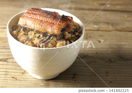 A single photo of a piping hot mini eel rice bowl. A single photo of a piping hot mini eel rice bowl. 141882225