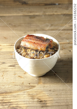 A single photo of a piping hot mini eel rice bowl. A single photo of a piping hot mini eel rice bowl. 141882232
