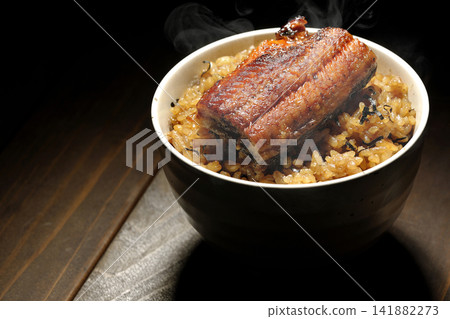 A single photo of a piping hot mini eel rice bowl. A single photo of a piping hot mini eel rice bowl. 141882273