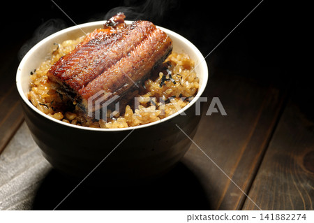 A single photo of a piping hot mini eel rice bowl. A single photo of a piping hot mini eel rice bowl. 141882274