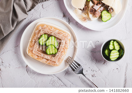 Delicious jellied chicken with mayonnaise on a plate on the table top view Delicious jellied chicken with mayonnaise on a plate on the table top view 141882660