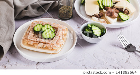 Delicious jellied chicken with mayonnaise on a plate on the table web banner Delicious jellied chicken with mayonnaise on a plate on the table web banner 141882664