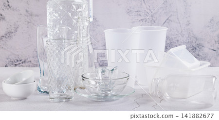 Concept of microplastic harm. Glass and plastic dishes on the table web banner Concept of microplastic harm. Glass and plastic dishes on the table web banner 141882677