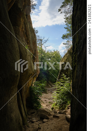 weathered stone walls and towering rock cliffs weathered stone walls and towering rock cliffs 141882821