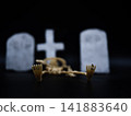 Skeleton in Halloween cemetery black background 141883640