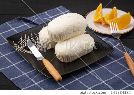steamed coconut milk buns topped with shredded desiccated coconut steamed coconut milk buns topped with shredded desiccated coconut 141884323