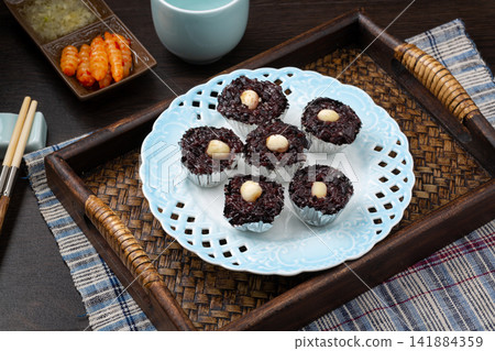 steamed black rice cake fa gao topped with white nuts steamed black rice cake fa gao topped with white nuts 141884359
