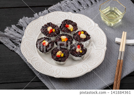 steamed black rice cake fa gao topped with white nuts steamed black rice cake fa gao topped with white nuts 141884361