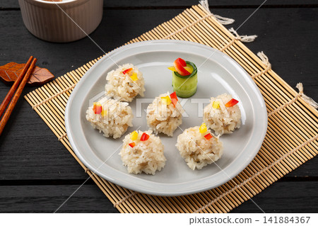 steamed pearl meatballs coated with glutinous rice and lotus root steamed pearl meatballs coated with glutinous rice and lotus root 141884367