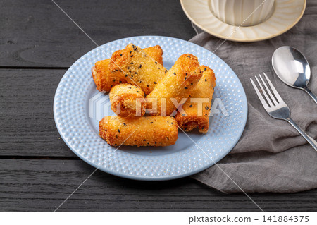 deep fried milk pudding rolls with crispy golden breadcrumbs 141884375