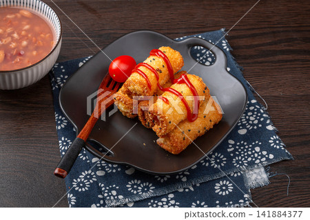 deep fried milk pudding rolls with crispy golden breadcrumbs deep fried milk pudding rolls with crispy golden breadcrumbs 141884377