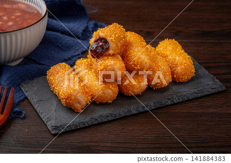 deep fried crispy sticky rice cake rolls with breadcrumbs coating deep fried crispy sticky rice cake rolls with breadcrumbs coating 141884383