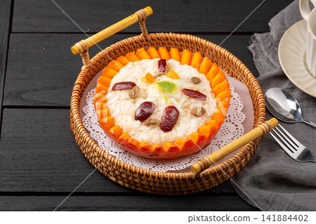 sweet eight treasure glutinous rice served inside a pumpkin shell sweet eight treasure glutinous rice served inside a pumpkin shell 141884402