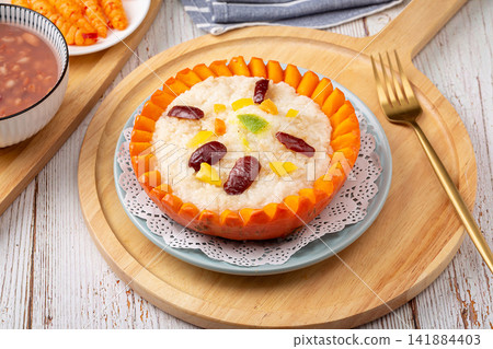 sweet eight treasure glutinous rice served inside a pumpkin shell sweet eight treasure glutinous rice served inside a pumpkin shell 141884403