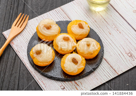sweet mango pudding rice cakes topped with coconut cream and raisins sweet mango pudding rice cakes topped with coconut cream and raisins 141884436