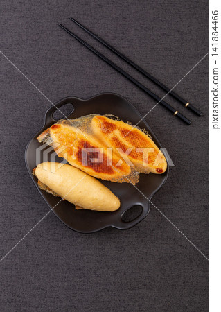 pan fried cornmeal potstickers with crispy golden lace crust 141884466