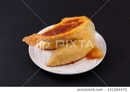 pan fried cornmeal potstickers with crispy golden lace crust pan fried cornmeal potstickers with crispy golden lace crust 141884470