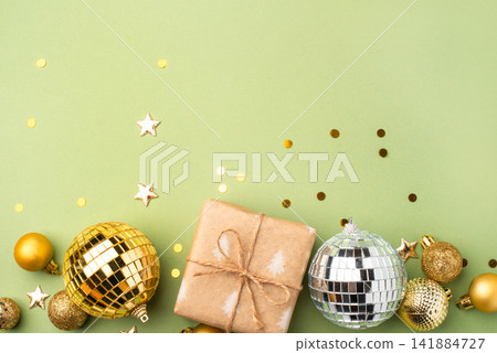Christmas gift with ornaments on a green background Christmas gift with ornaments on a green background 141884727