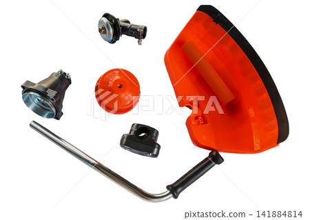 High angle view of orange grass cutter attachment accessories on a white background High angle view of orange grass cutter attachment accessories on a white background 141884814