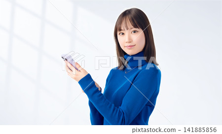 Women and businesswomen who own smartphones Women and businesswomen who own smartphones 141885856