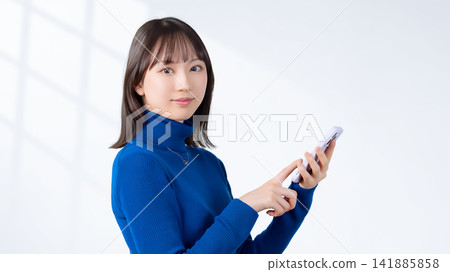 Women and businesswomen who own smartphones Women and businesswomen who own smartphones 141885858
