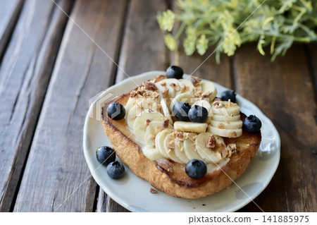 Gourmet toast with banana, blueberries, and candied nuts Gourmet toast with banana, blueberries, and candied nuts 141885975