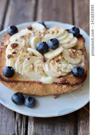 Banana, blueberry, and candied nut toast variation Banana, blueberry, and candied nut toast variation 141885995
