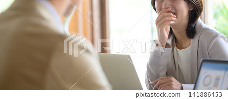A man talking to a laughing woman A man talking to a laughing woman 141886453