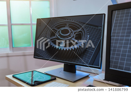 Modern desk with a computer monitor a gear design, a tablet and a second screen near a bright window in a clean office workspace. Modern desk with a computer monitor a gear design, a tablet and a second screen near a bright window in a clean office workspace. 141886799
