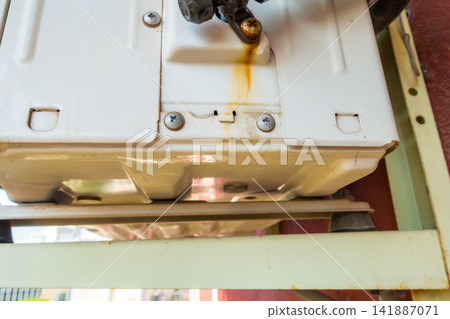 Outdoor Air Conditioning Unit with Water Dripping from Pipe Fittings Outdoor Air Conditioning Unit with Water Dripping from Pipe Fittings 141887071